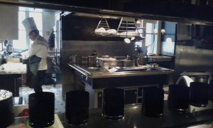 La cucina del bar con il cuoco intento a lavorare.